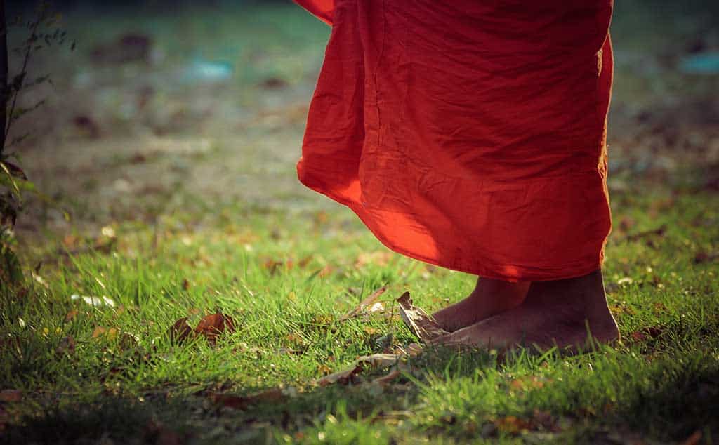 Buddhist monk walking meditation performing meditative walking on the grass,Vintage Tone.